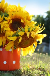 Bouquet of beautiful sunflowers in tin outdoors