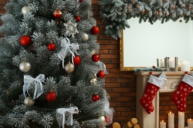 Photo of Stylish interior with beautiful Christmas tree and decorative fireplace