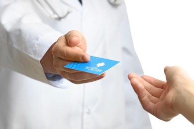 Photo of Doctor giving business card to patient isolated on white, closeup. Medical service