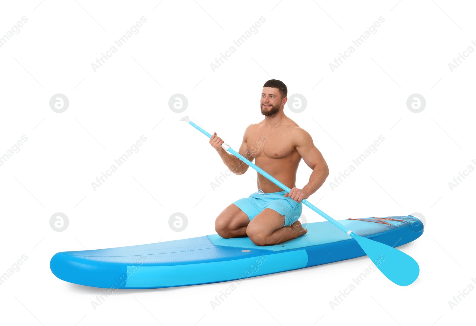 Photo of Handsome man with paddle on blue SUP board against white background