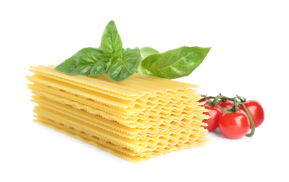 Photo of Uncooked lasagna sheets, cherry tomatoes and basil isolated on white