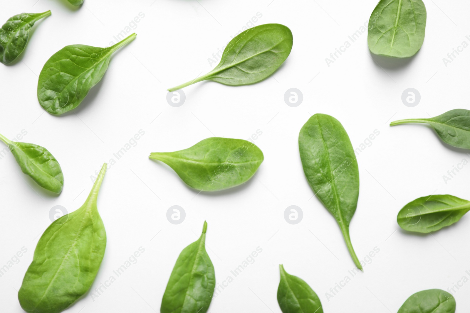 Photo of Fresh green healthy spinach leaves on white background, top view