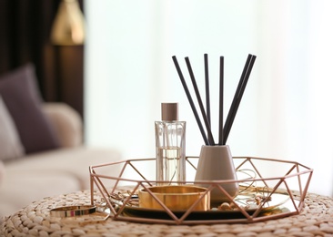 Photo of Composition with stylish accessories and interior elements on wicker pouf indoors