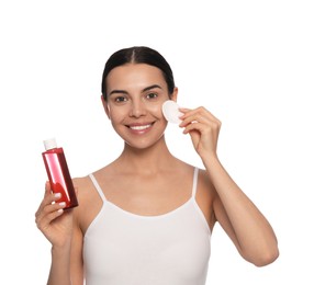 Photo of Young woman using cotton pad with micellar water on white background
