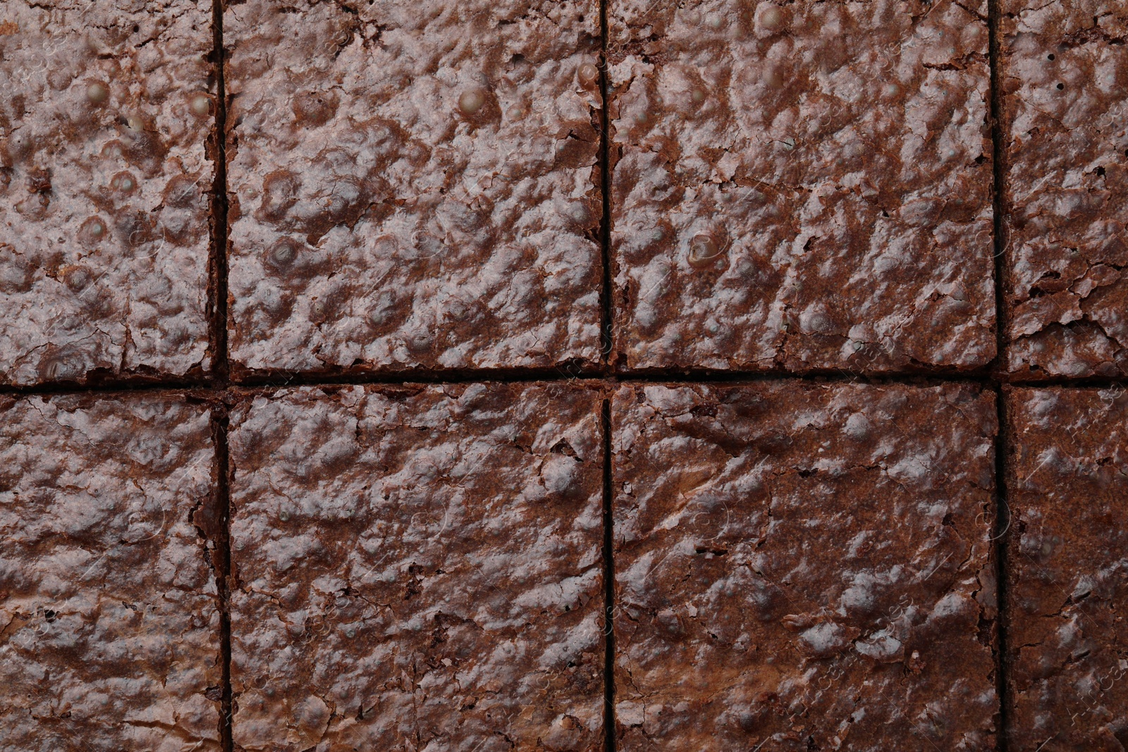 Photo of Closeup of delicious chocolate brownie as background, top view