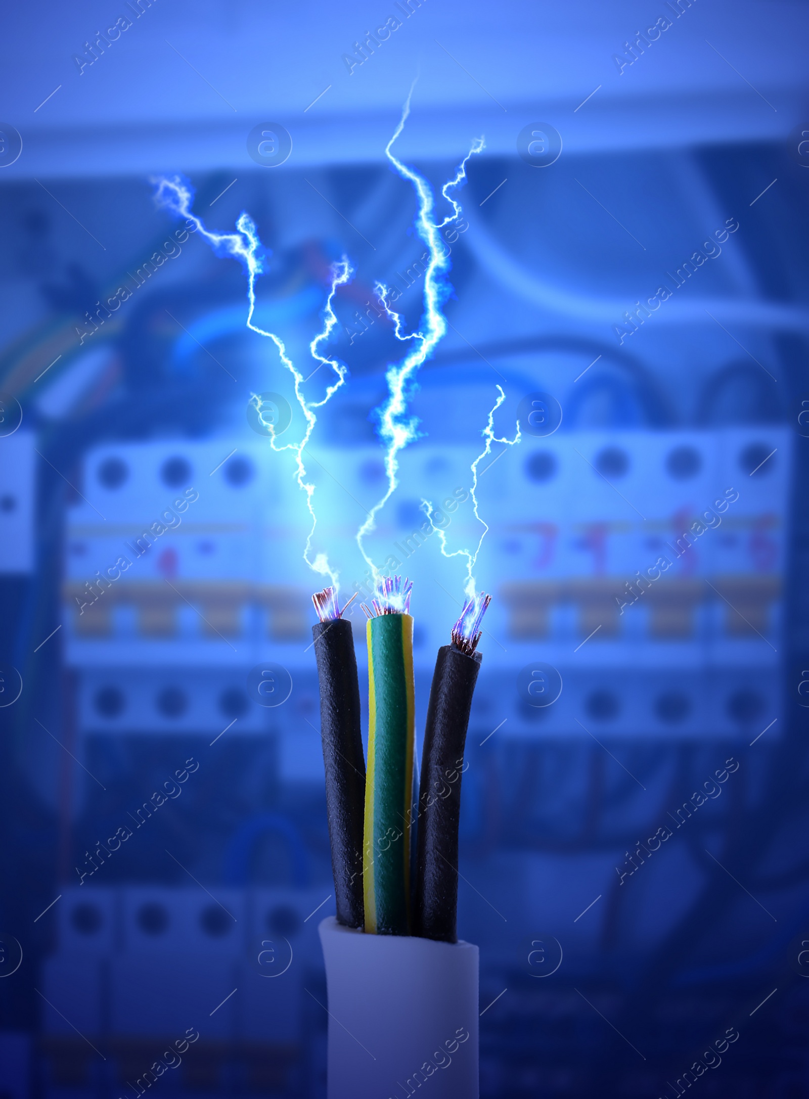 Image of Sparking cables against blurred electric cabinet, closeup