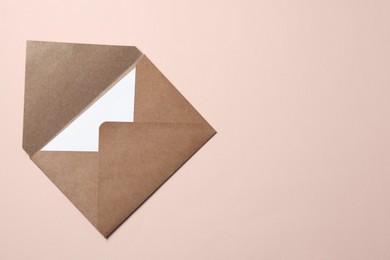 Photo of Letter envelope with card on beige background, top view. Space for text