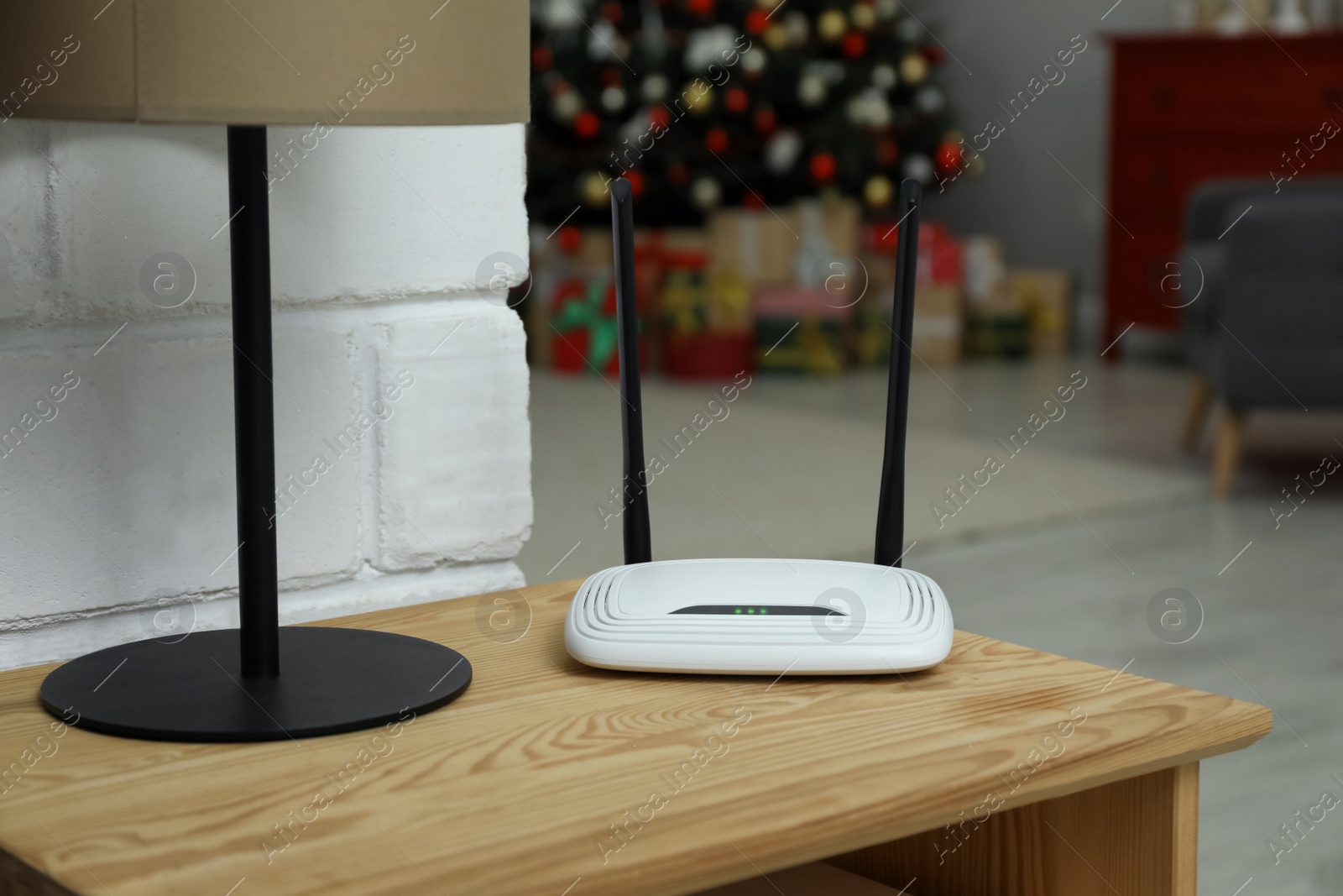 Photo of Wi-Fi router on wooden table in room