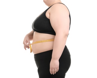 Overweight woman with measuring tape on white background