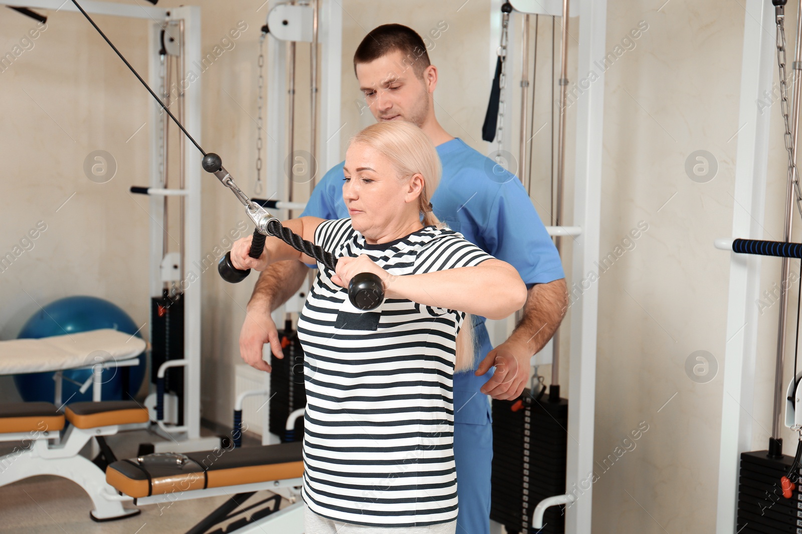 Photo of Patient exercising under physiotherapist supervision in rehabilitation center