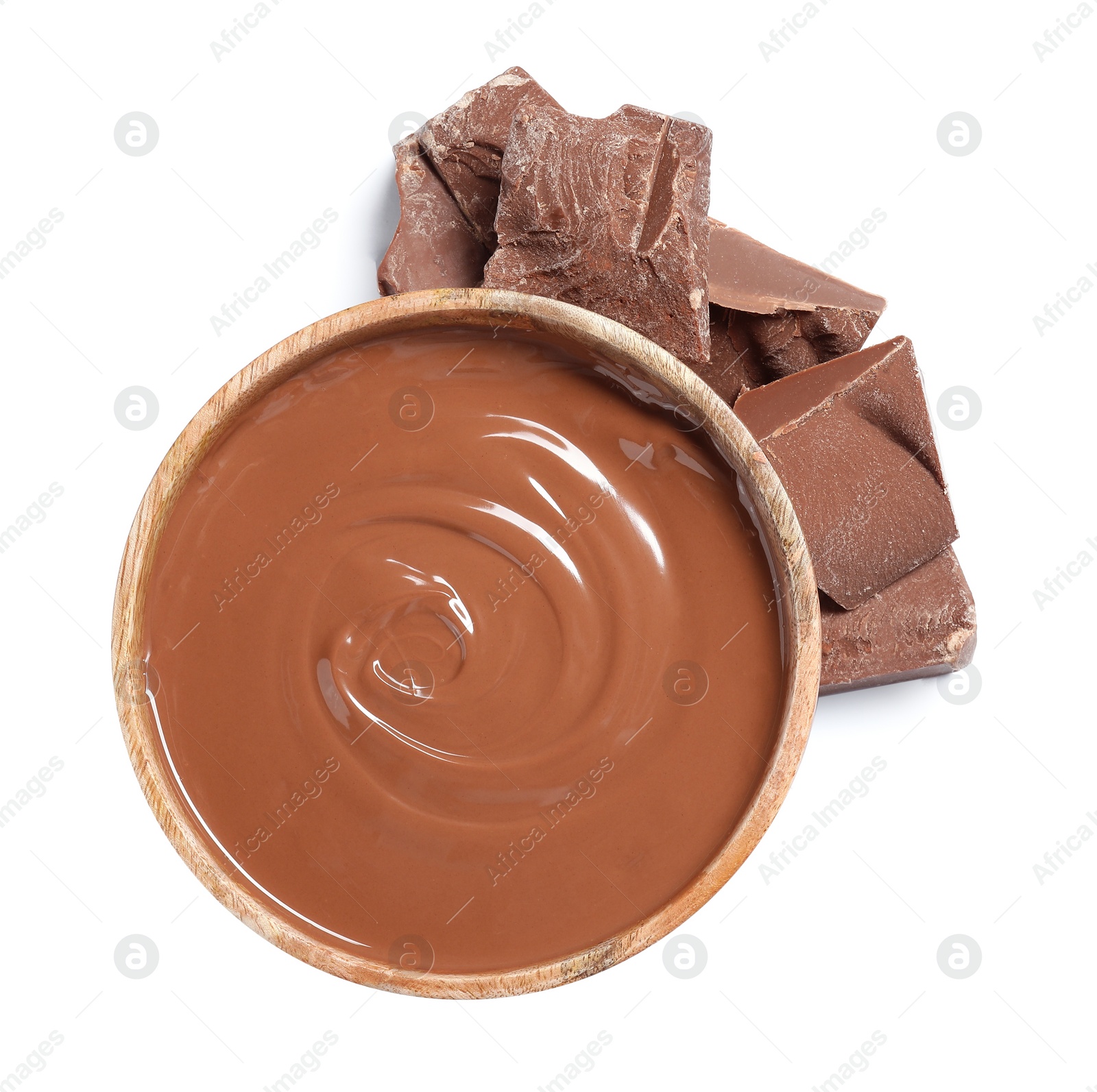 Photo of Tasty milk chocolate paste in bowl and pieces isolated on white, top view