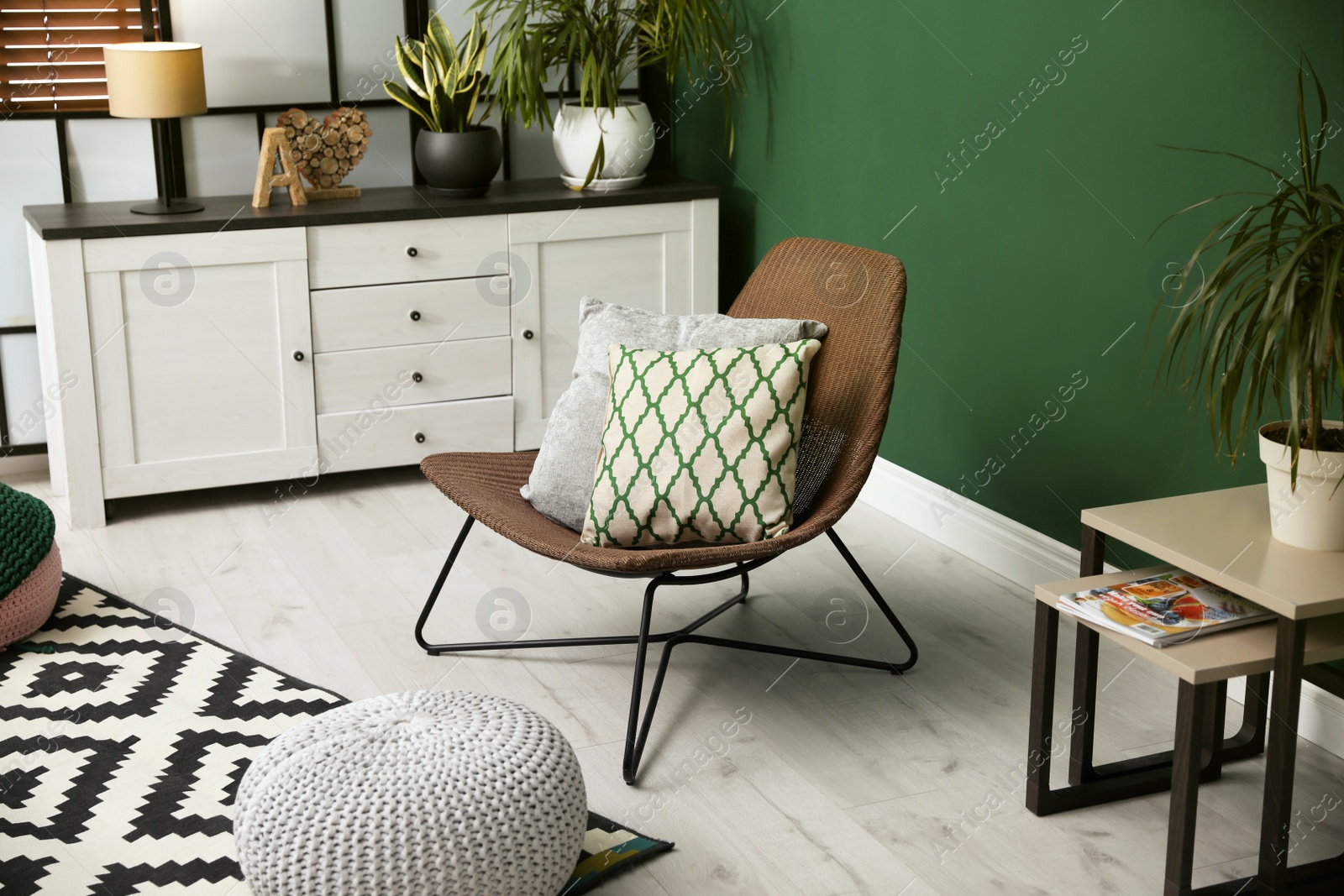 Photo of Elegant room interior with comfortable wicker armchair