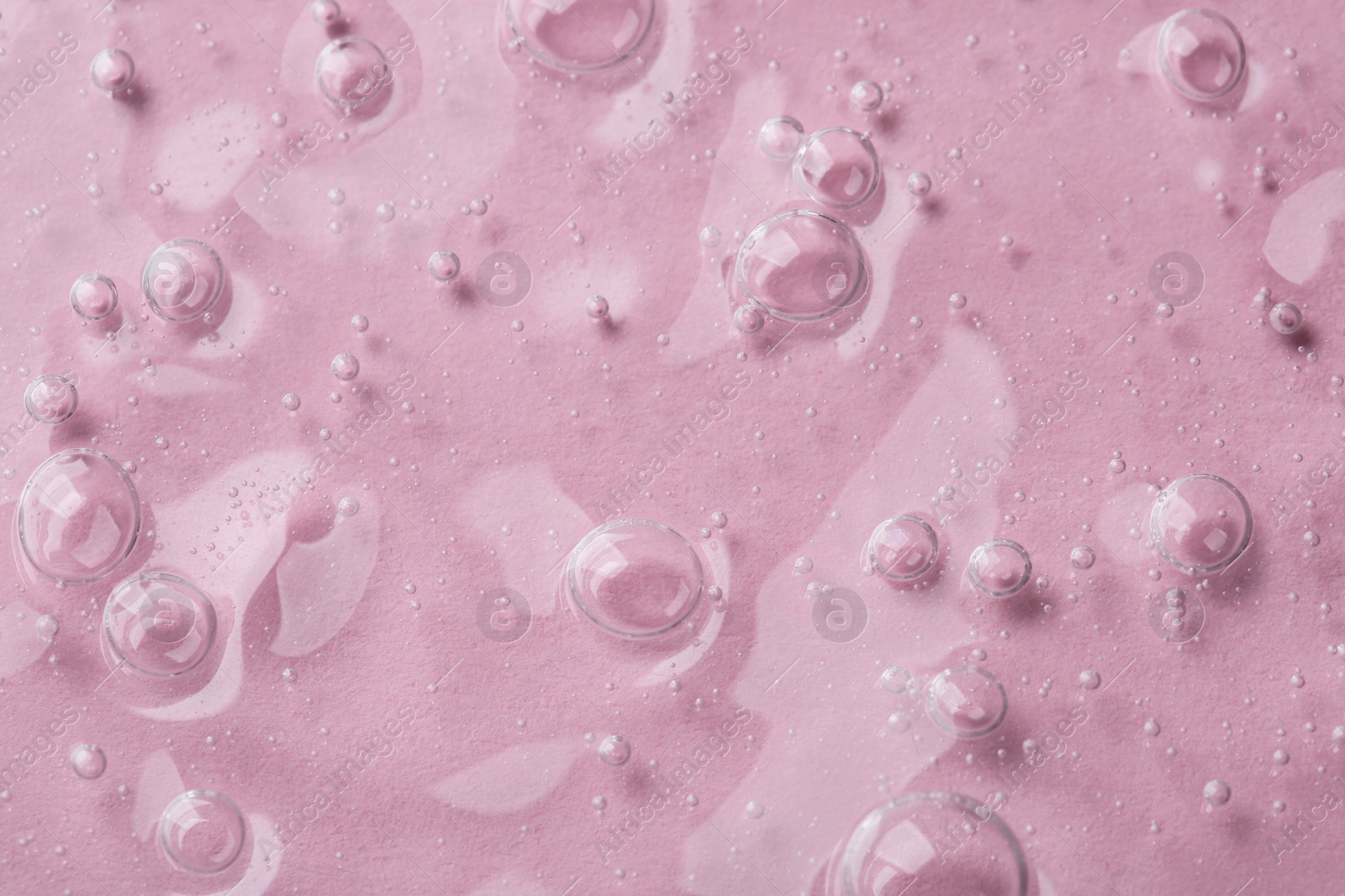 Photo of Cosmetic serum on pink background, top view