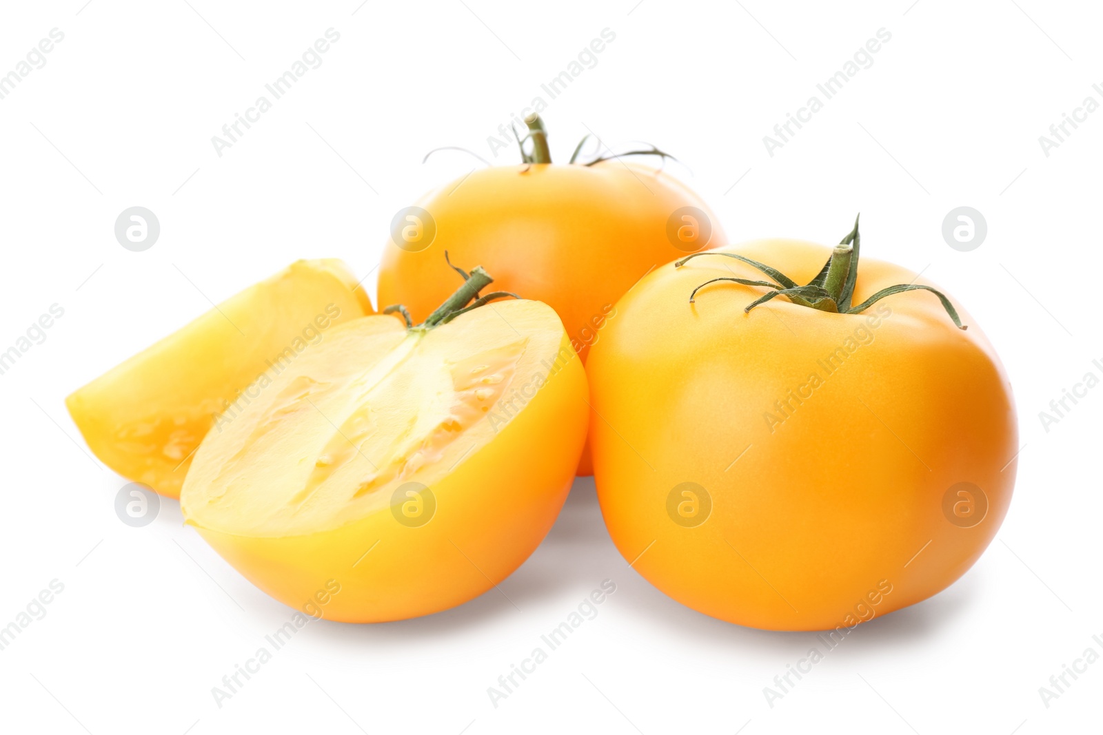 Photo of Cut ripe yellow tomatoes isolated on white