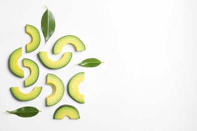 Composition with sliced ripe avocado on white background