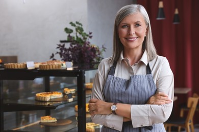Photo of Portrait of happy business owner in her cafe, space for text
