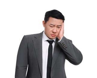 Tired businessman in suit posing on white background