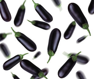 Many fresh eggplants falling on white background