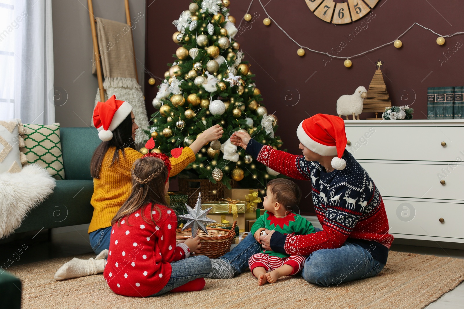 Photo of Family decorating beautiful Christmas tree at home