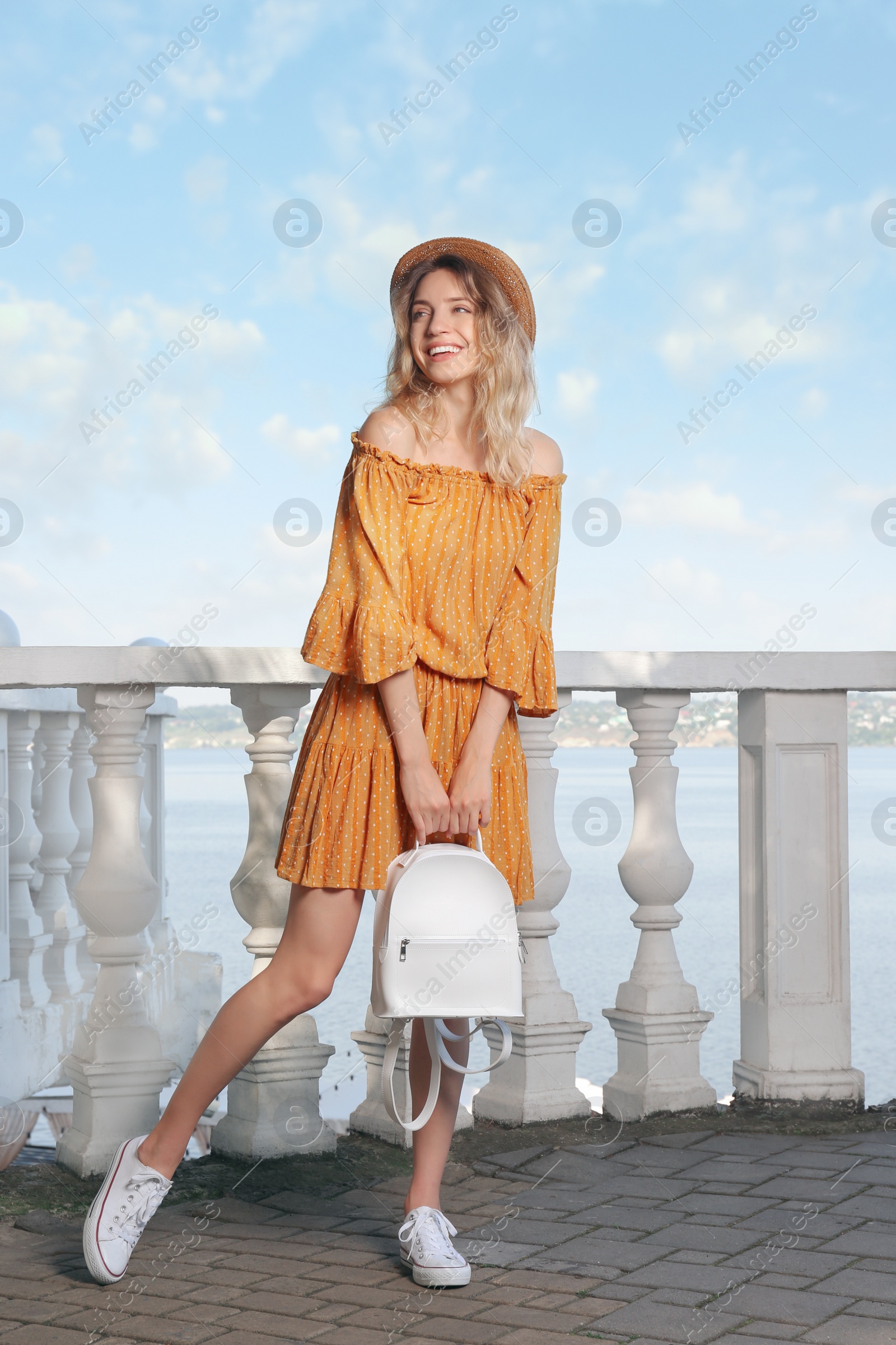 Photo of Beautiful young woman with stylish backpack outdoors