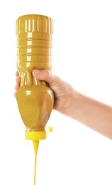 Woman with bottle of mustard on white background, closeup