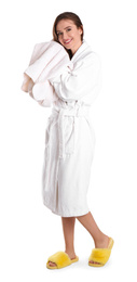 Young woman in bathrobe drying hair with towel on white background