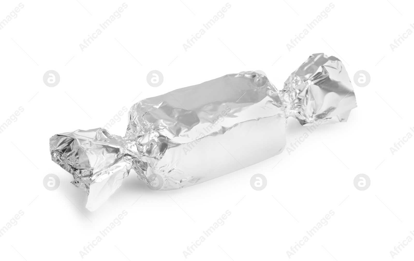 Photo of Tasty candy in silver wrapper isolated on white