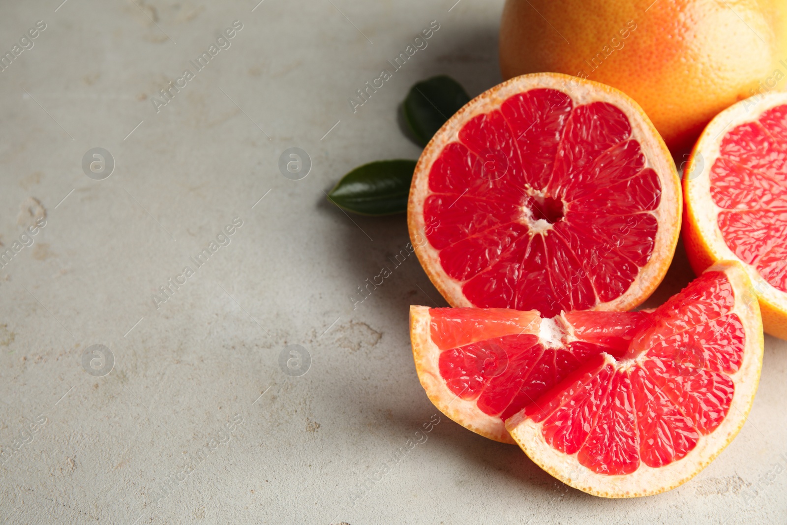 Photo of Fresh tasty grapefruits on table. Space for text