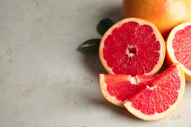 Photo of Fresh tasty grapefruits on table. Space for text