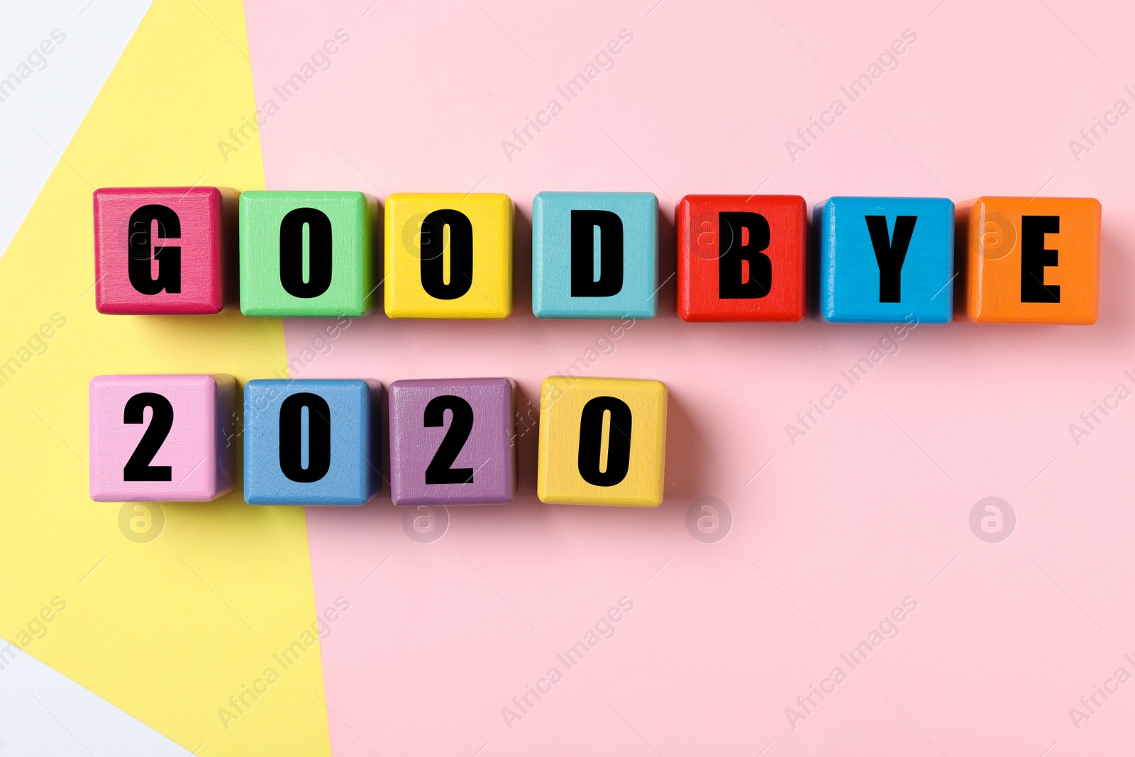 Photo of Cubes with phrase Goodbye 2020 on color background, flat lay