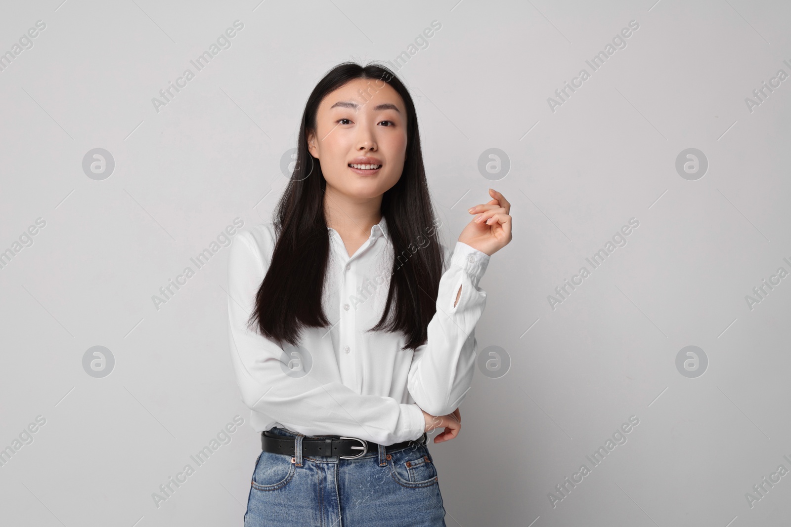 Photo of Portrait of smiling woman on light background