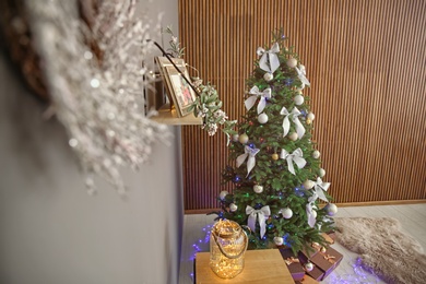 Photo of Beautiful Christmas tree and gift boxes indoors