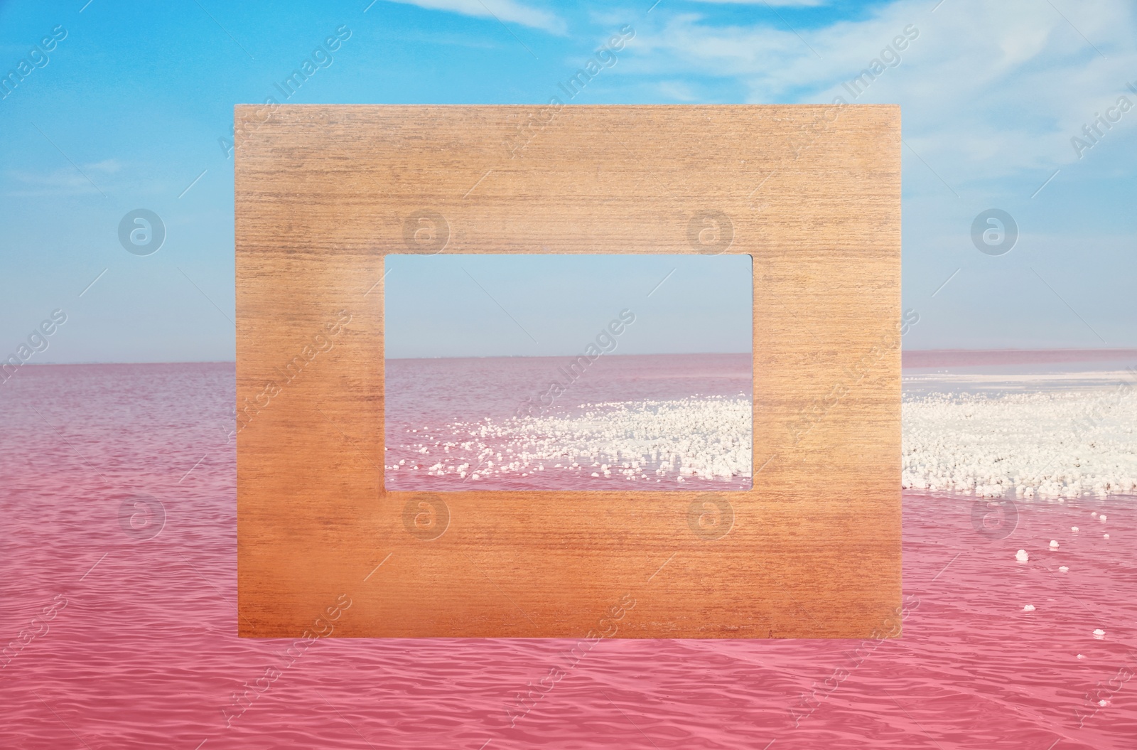 Image of Wooden frame and beautiful pink lake under blue sky with clouds