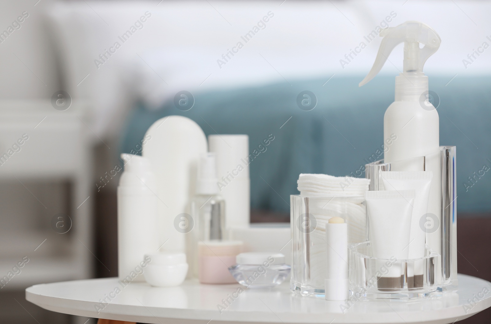Photo of Set of cosmetic products on table against blurred background. Space for text
