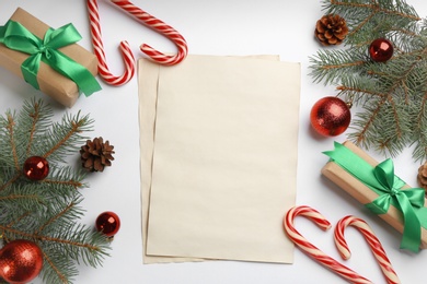 Photo of Flat lay composition with blank sheets of paper on white background, space for text. Writing letter to Santa