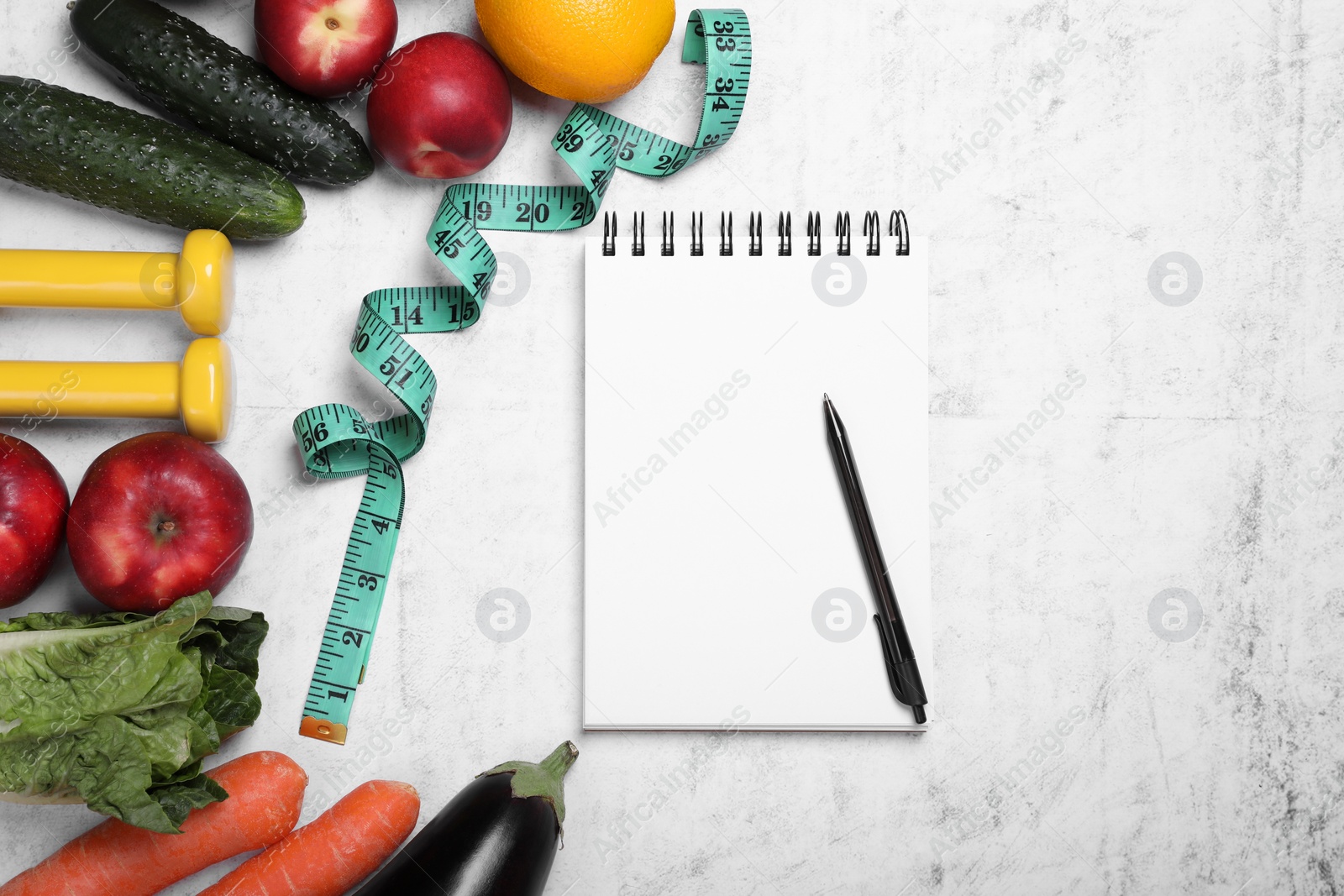 Photo of Measuring tape, notebook, fresh fruits and vegetables on light gray textured table, flat lay. Low glycemic index diet