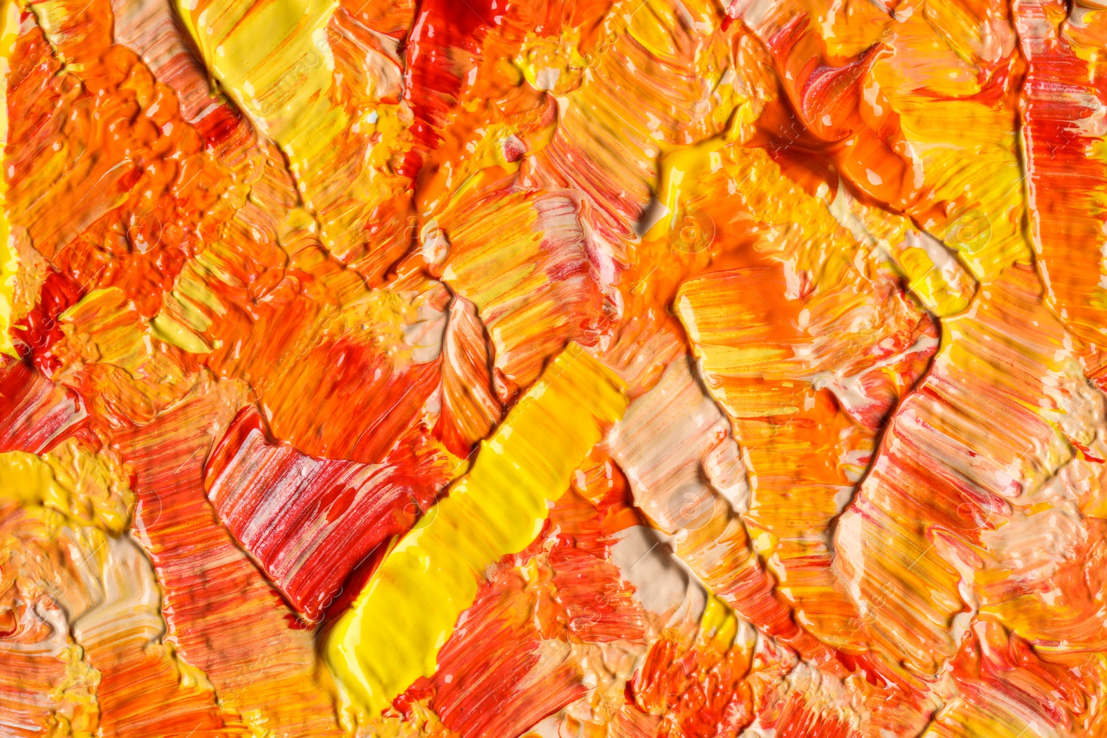 Photo of Beautiful strokes of colorful oil paints as background, closeup