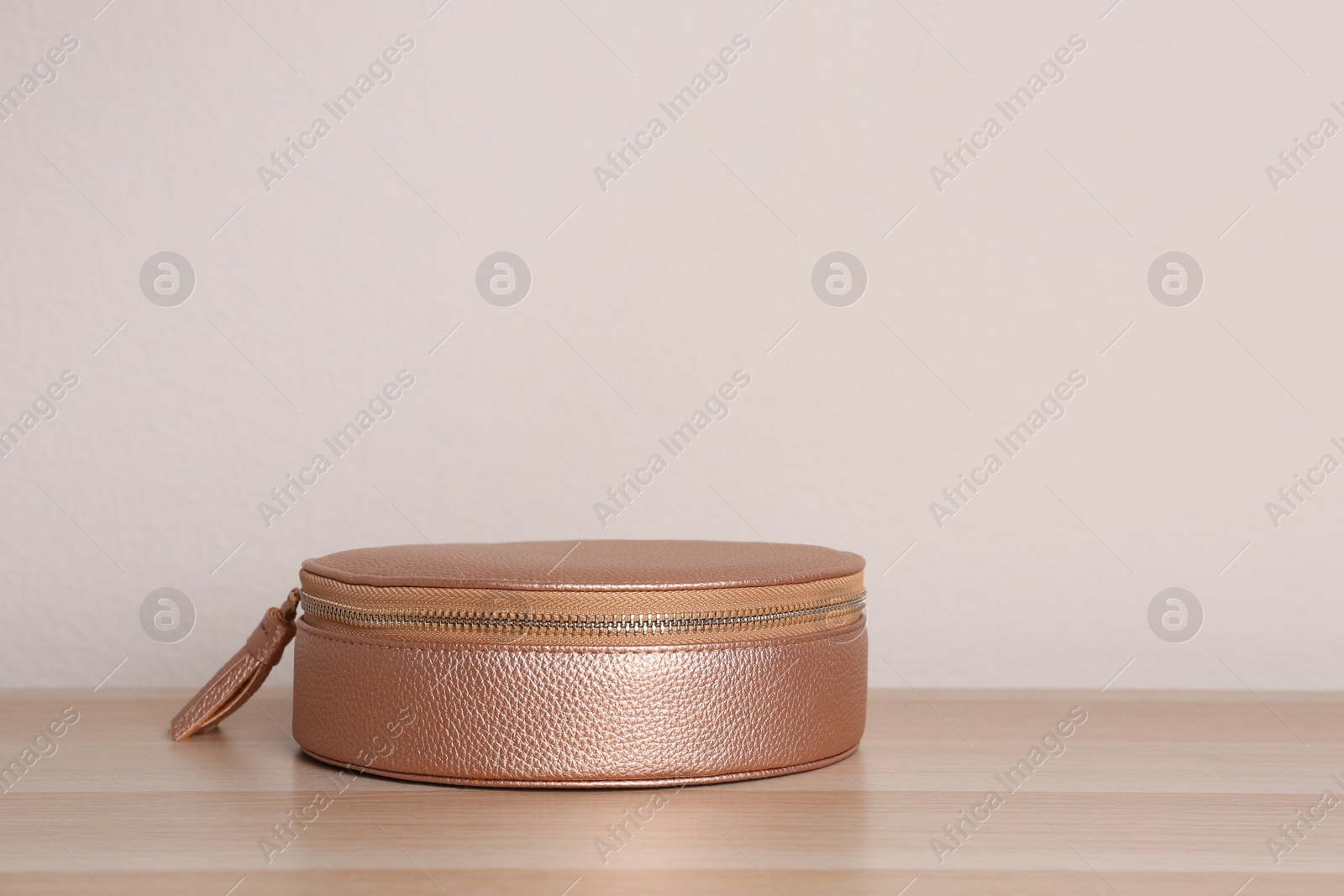 Photo of Stylish leather woman's bag on wooden table