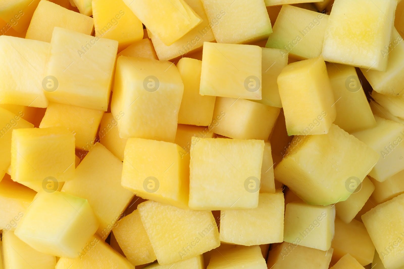 Photo of Many delicious mango cubes as background, closeup