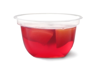 Photo of Tasty jelly dessert with slices of fruit in plastic cup on white background