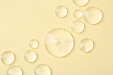 Photo of Samples of cosmetic serum on beige background, flat lay