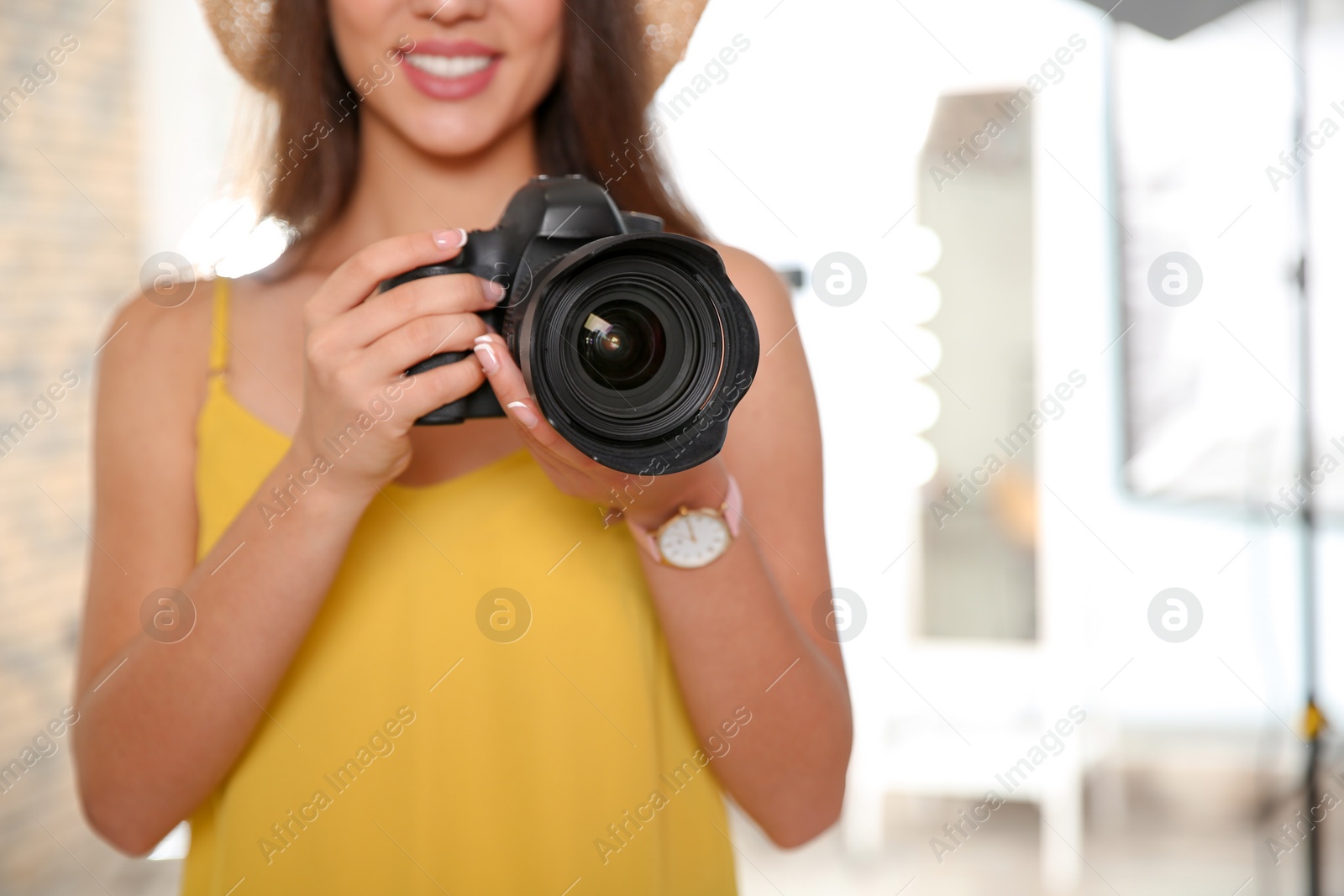 Photo of Professional photographer with camera in photo studio