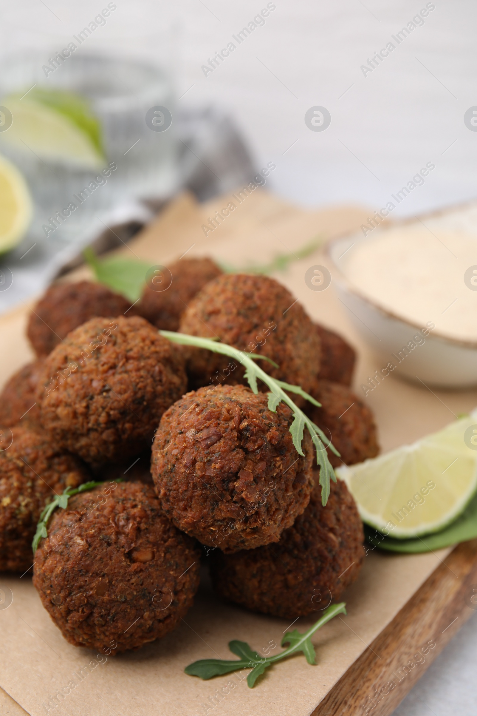 Photo of Delicious falafel balls and arugula on table, closeup