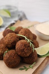 Photo of Delicious falafel balls and arugula on table, closeup