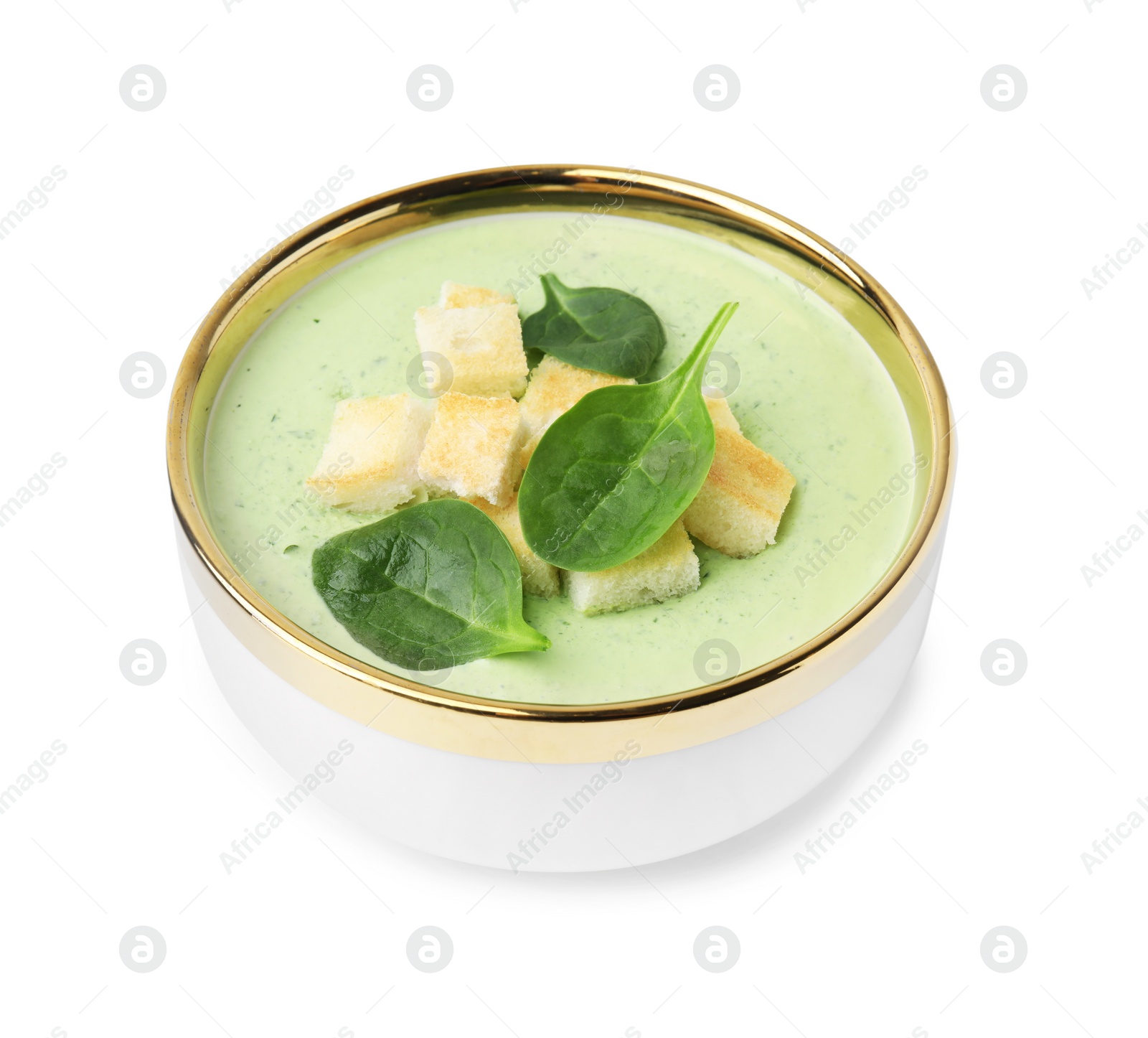 Photo of Delicious spinach cream soup with croutons in bowl isolated on white