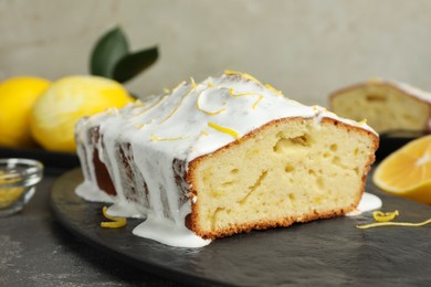 Photo of Tasty lemon cake with glaze on table, closeup