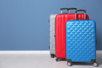 Photo of Different suitcases near color wall