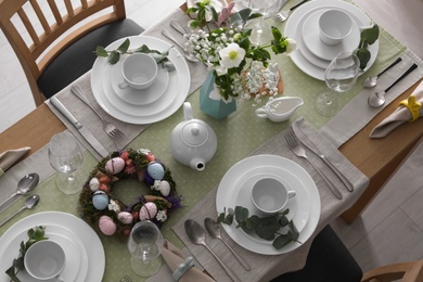 Beautiful Easter table setting with festive decor indoors, above view