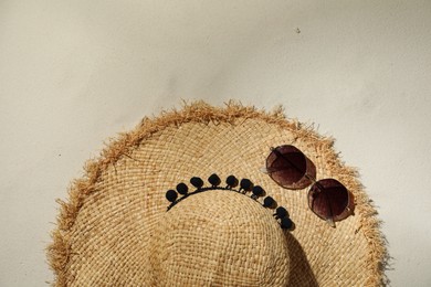 Photo of Flat lay composition with hat and sunglasses on sand. Beach objects