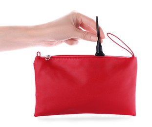 Photo of Woman taking out eyeliner from red cosmetic bag on white background, closeup